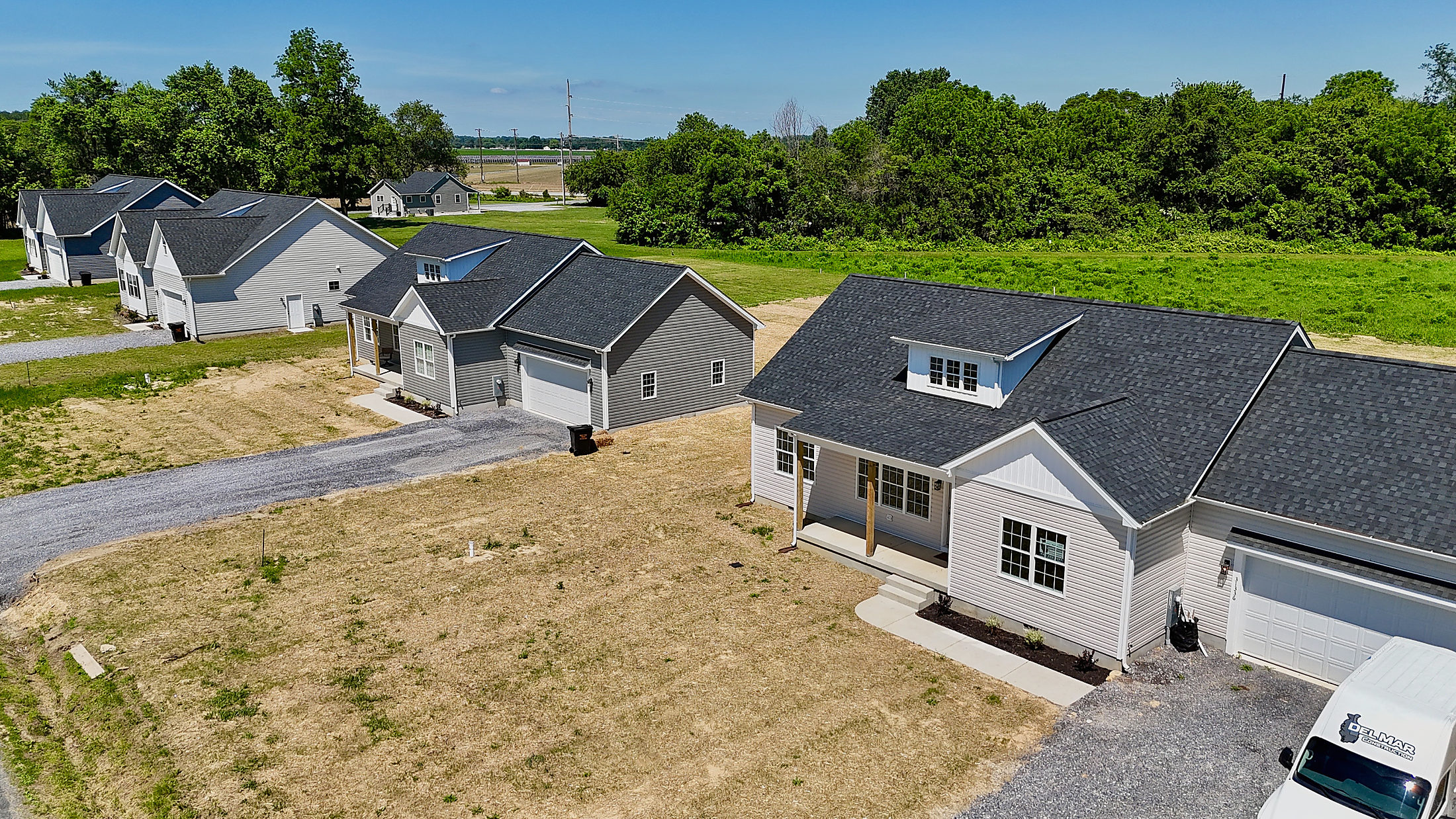 Aerial view of new homes with dark architectural shingle roofs on the Eastern Shore