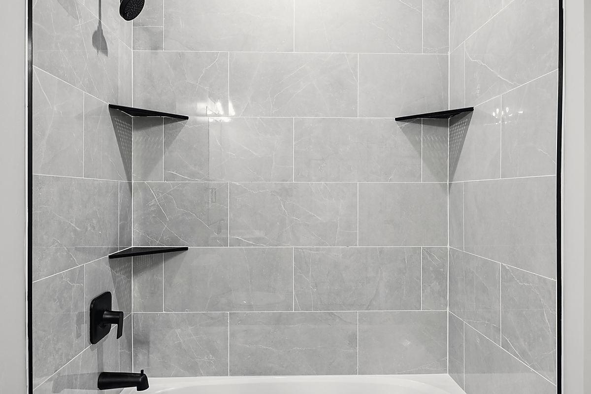 A Del Mar bathroom: a soaking tub under an arched window