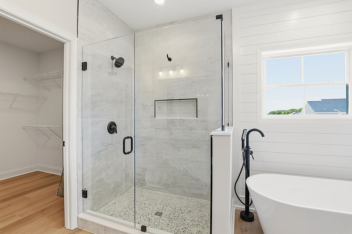 A Del Mar bathroom: a glass shower beside a freestanding tub