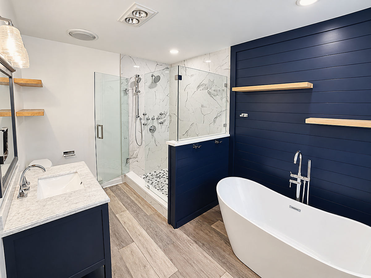 A Del Mar bathroom: a navy shiplap wall behind a freestanding tub
