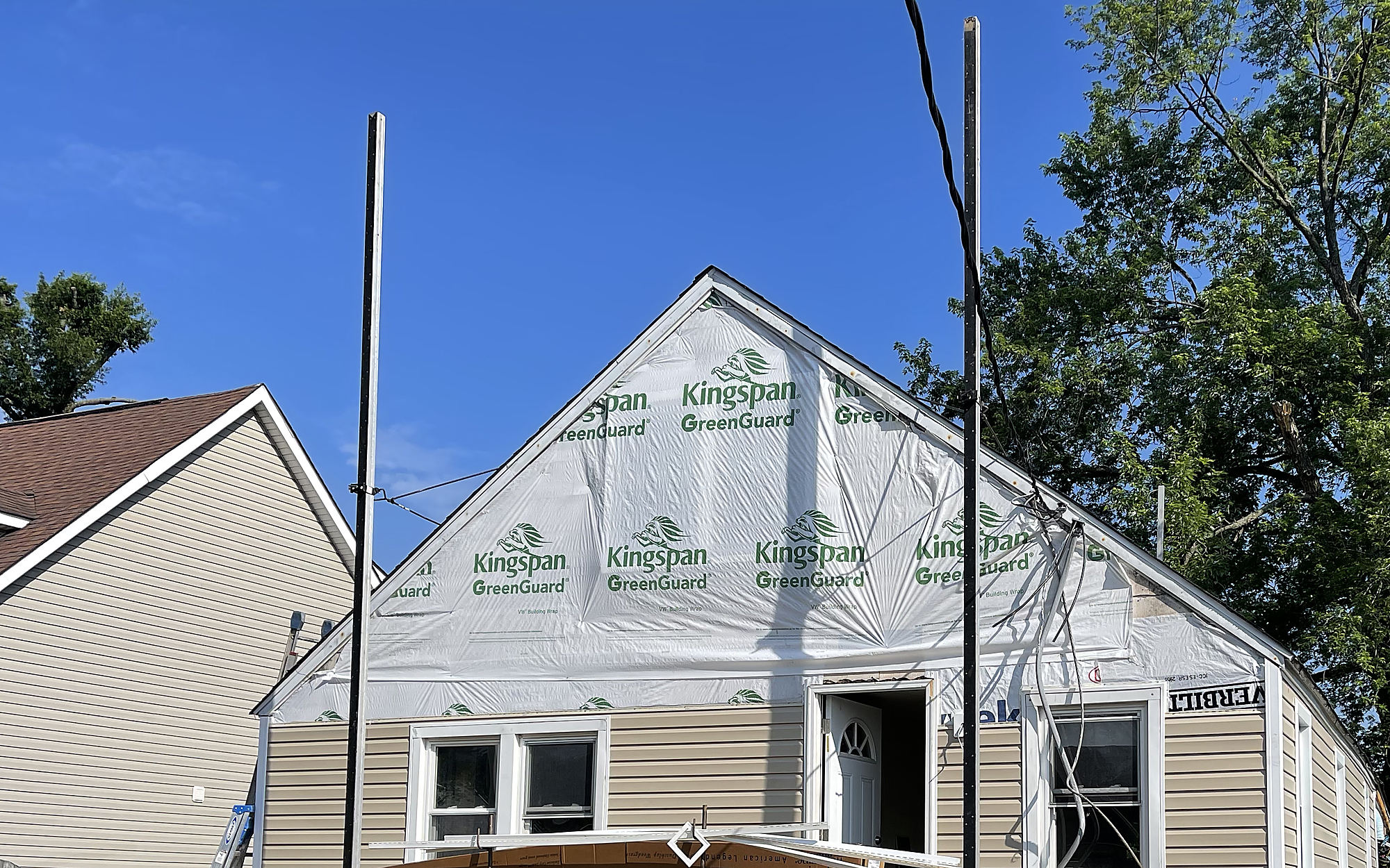A full gut renovation underway with new house wrap and framing