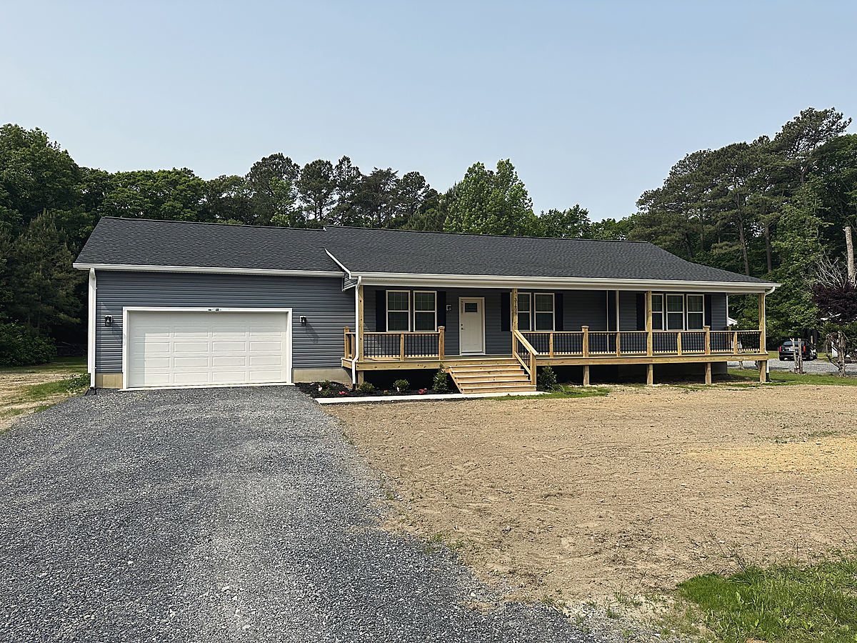 A custom home in Trappe: the front of a gray custom home with a garage