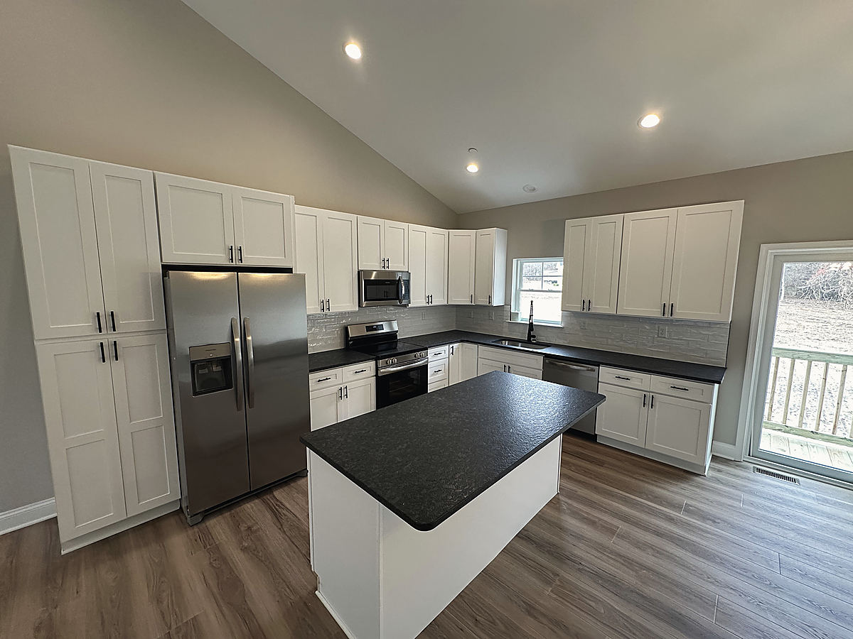 A custom home in Preston: a kitchen with dark counters