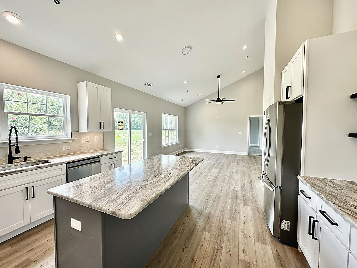 Four custom homes in Cordova: a kitchen with an island