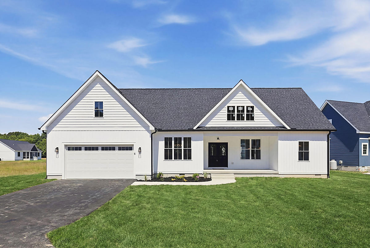 A coastal ranch in Berlin: the front of a white coastal ranch with a covered porch