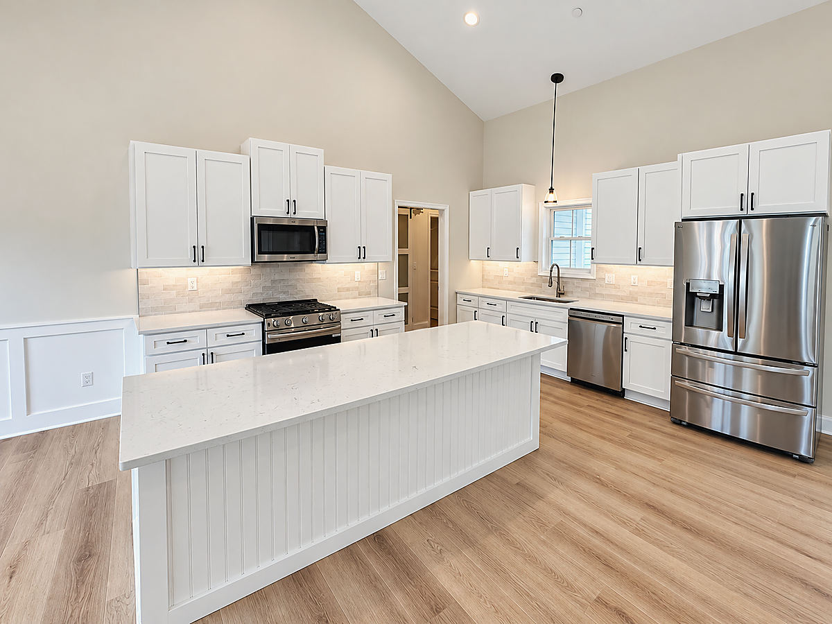 A Del Mar kitchen: a bright kitchen with a white island under a vaulted ceiling