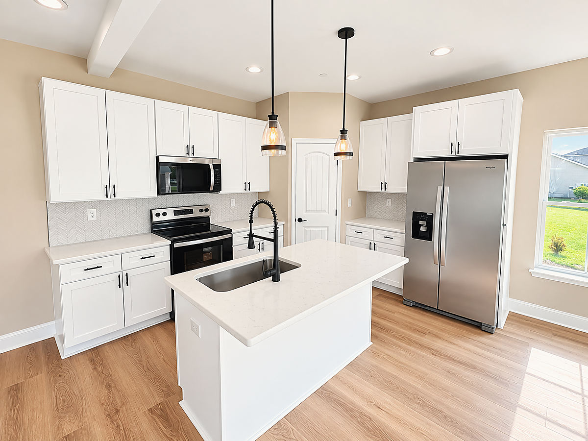 A Del Mar kitchen: a white kitchen with an island and black pendants