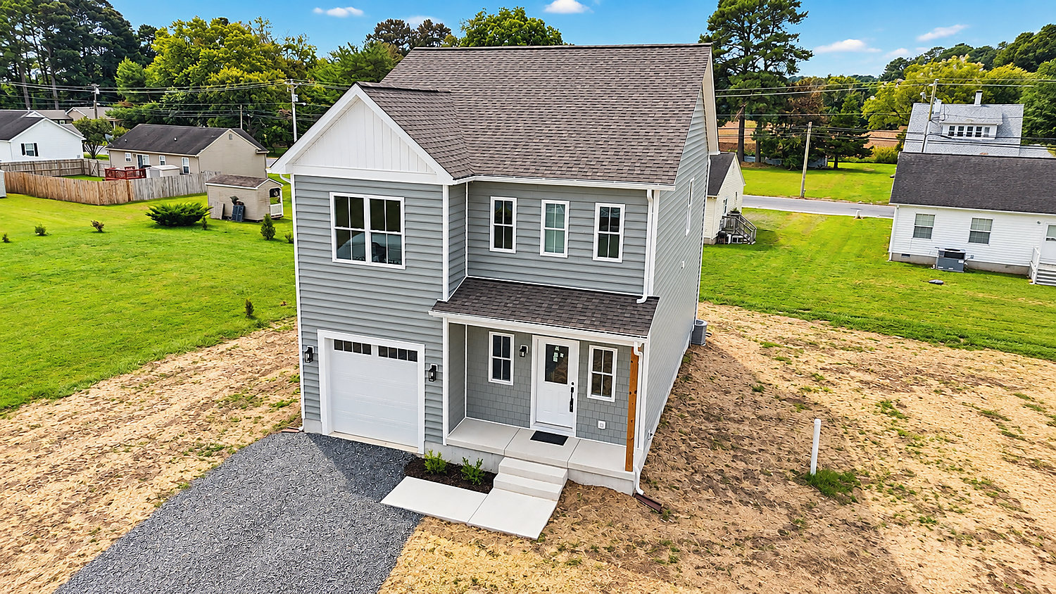 1402 Cedar Run, Pocomoke City: a new two-story colonial with gray siding and an attached garage