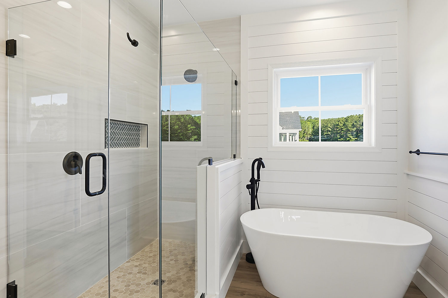 The primary bath at 5 Seattle Slew Lane: freestanding tub and frameless glass shower