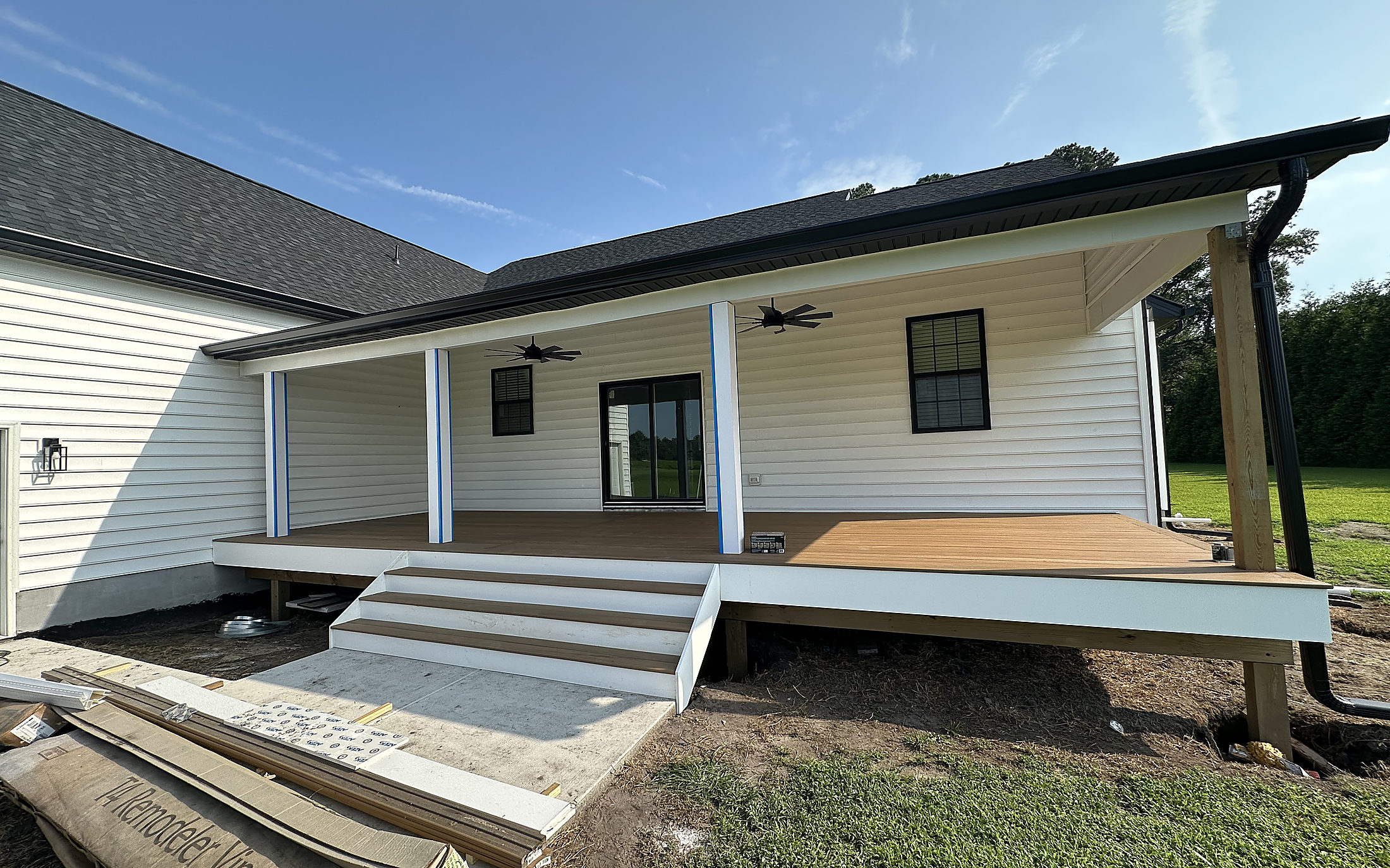Black seamless gutters on a new covered porch