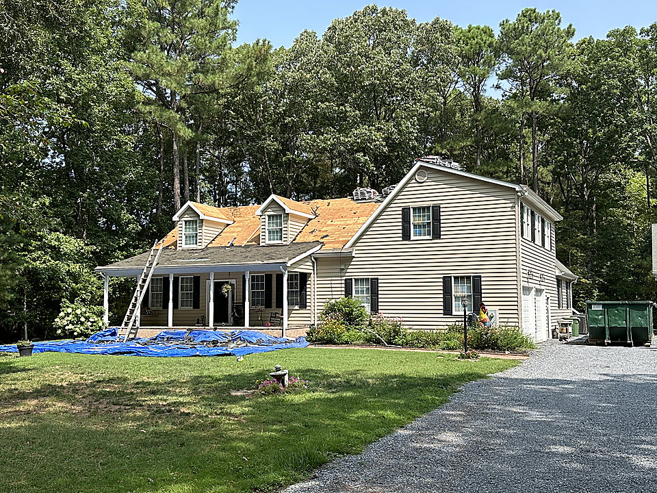 A storm damaged roof being replaced