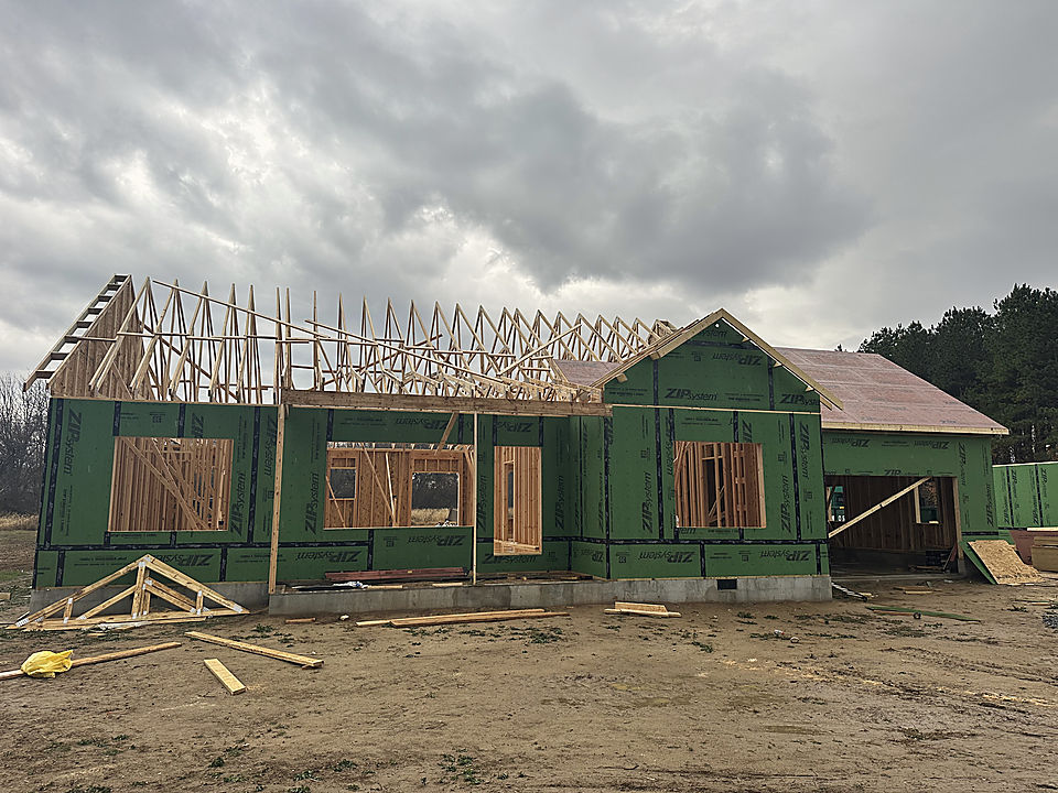 Walls framed and roof trusses going up on a Del Mar home in Preston
