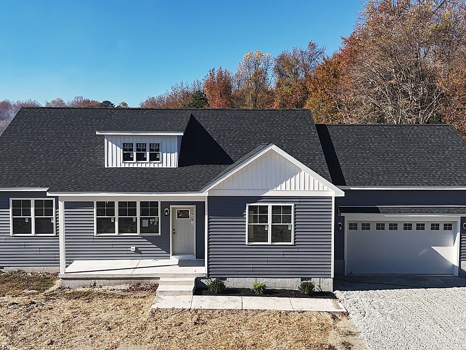 A finished Del Mar custom home in Preston with gray siding and a two-car garage