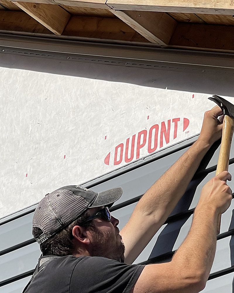 A Del Mar installer fastening new siding